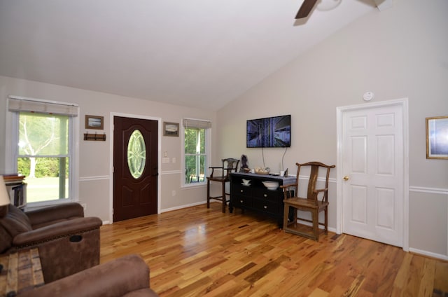 entryway featuring ceiling fan, light wood-type flooring, a wealth of natural light, and high vaulted ceiling