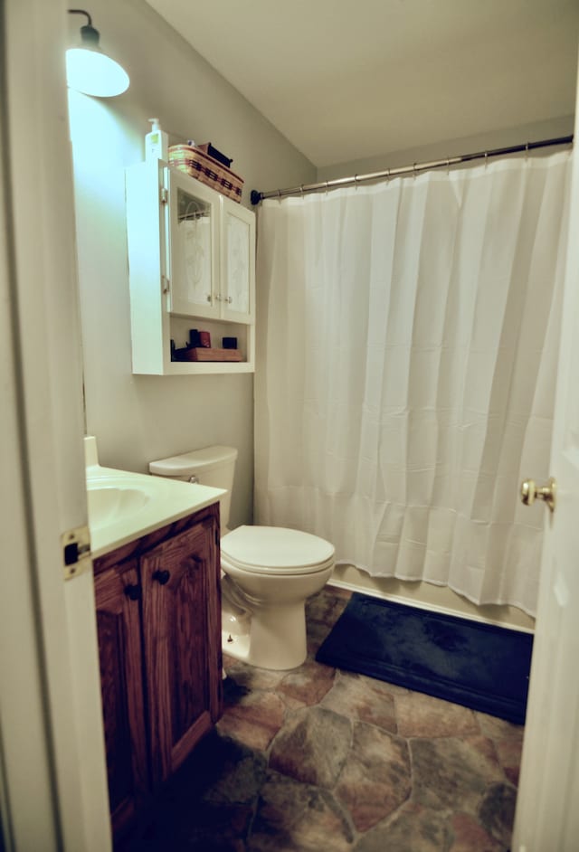 bathroom featuring vanity, toilet, and tile patterned flooring