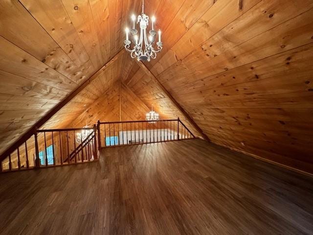 additional living space with an inviting chandelier, wooden walls, wooden ceiling, and vaulted ceiling