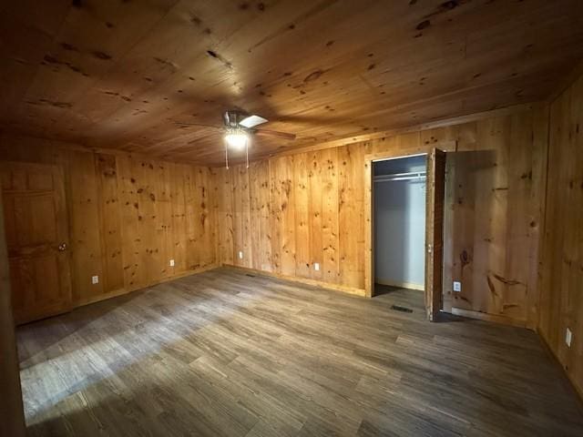 interior space featuring wood ceiling, wood walls, ceiling fan, and hardwood / wood-style flooring