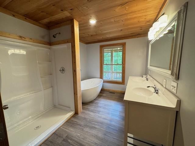 bathroom featuring shower with separate bathtub, wood-type flooring, wooden ceiling, and vanity