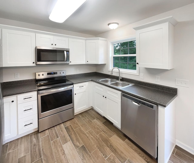 kitchen with sink, stainless steel appliances, and white cabinets