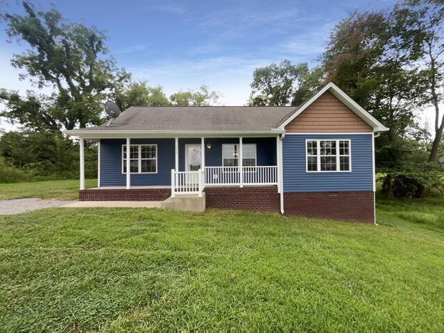 ranch-style house with a porch and a front yard