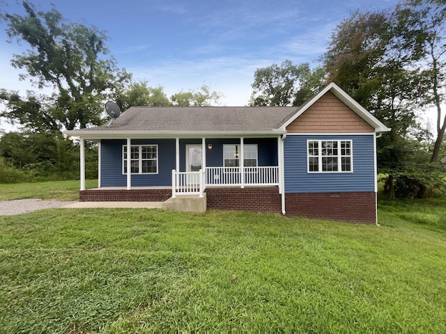 ranch-style home with a front yard and covered porch