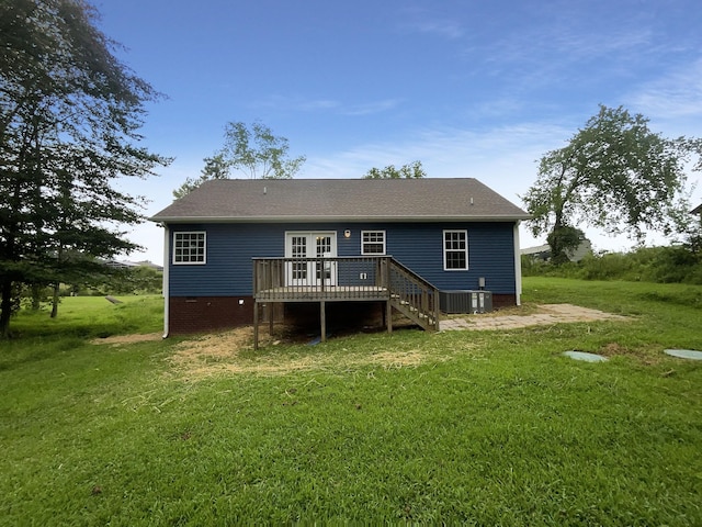 rear view of property with a wooden deck, a lawn, and cooling unit