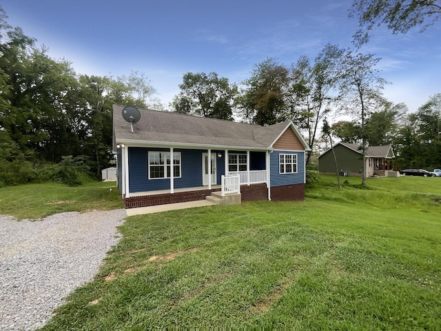 view of front of home featuring covered porch and a front lawn