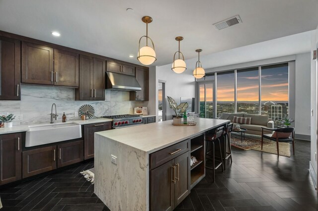 kitchen with sink, decorative backsplash, pendant lighting, and dark parquet floors