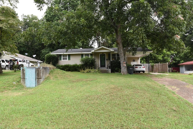 ranch-style home with a carport and a front yard