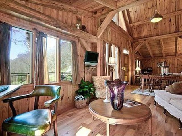 sunroom with wooden ceiling, a wealth of natural light, and lofted ceiling with beams