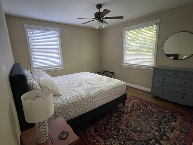 bedroom with ceiling fan and wood-type flooring