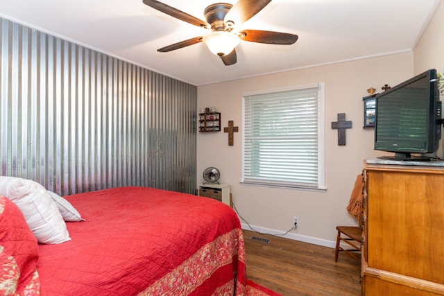 bedroom featuring crown molding, ceiling fan, and wood-type flooring