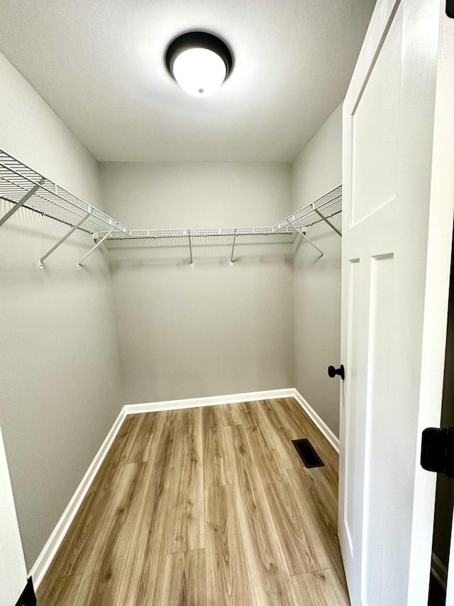 spacious closet featuring hardwood / wood-style flooring