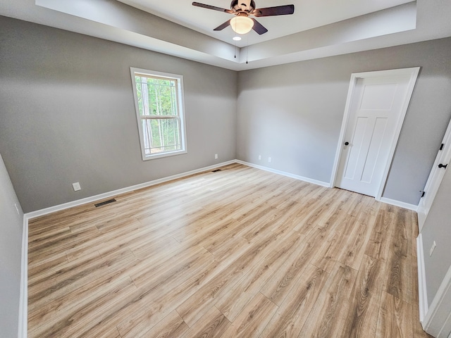 spare room with ceiling fan and light wood-type flooring