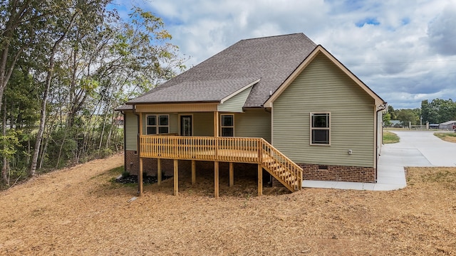 rear view of house featuring a deck