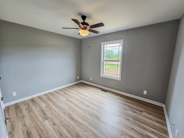 spare room with light hardwood / wood-style flooring and ceiling fan