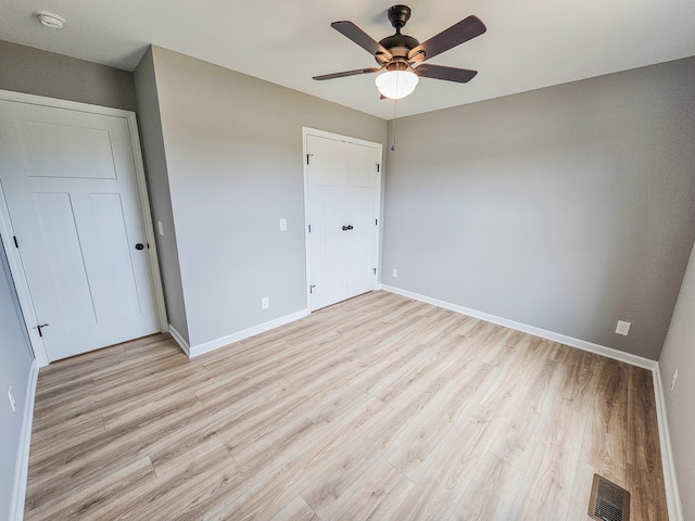 unfurnished bedroom featuring ceiling fan and light wood-type flooring