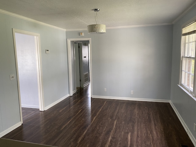 empty room with ornamental molding, a textured ceiling, and dark hardwood / wood-style floors