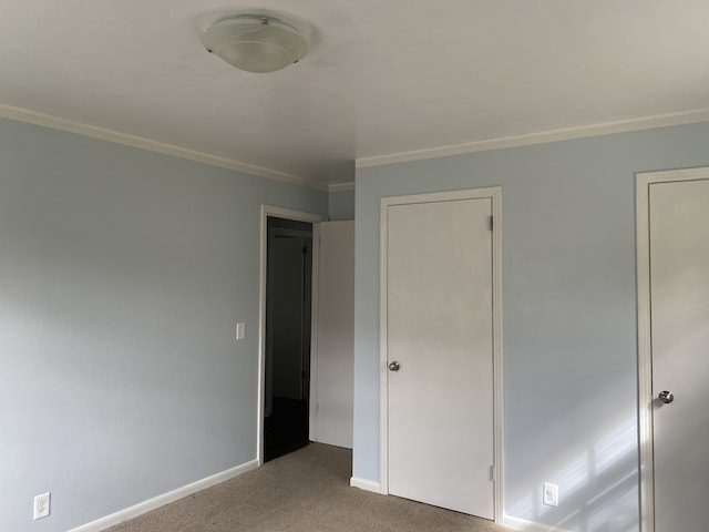 unfurnished bedroom featuring crown molding and carpet floors