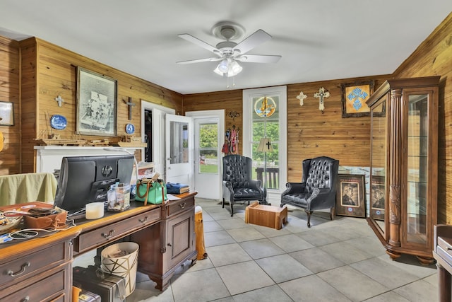 tiled office featuring wood walls and ceiling fan