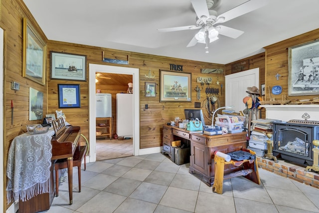 tiled office with a wood stove, ceiling fan, and wooden walls