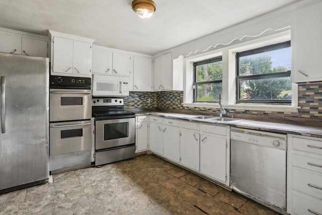 kitchen with sink, white cabinetry, tile patterned floors, and stainless steel appliances