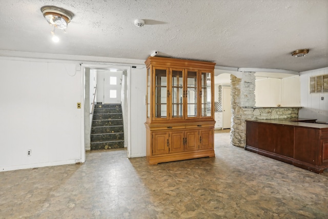 kitchen featuring tile patterned flooring and a textured ceiling