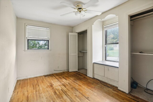 unfurnished bedroom featuring wood-type flooring and ceiling fan