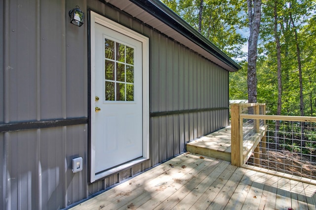 view of exterior entry with a wooden deck