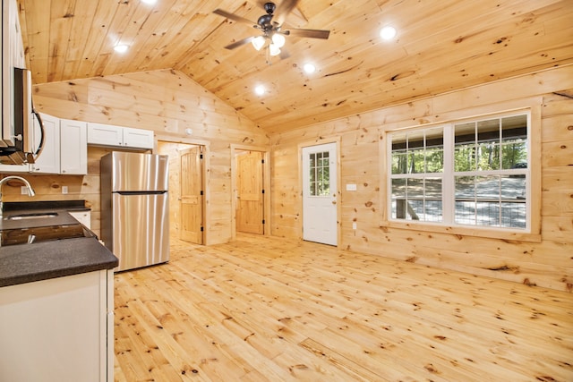 kitchen featuring light wood-type flooring, wood ceiling, stainless steel appliances, white cabinetry, and ceiling fan