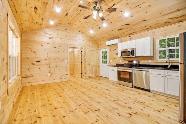 kitchen featuring ceiling fan, appliances with stainless steel finishes, white cabinets, and light hardwood / wood-style floors