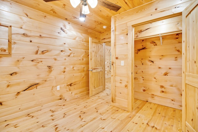 interior space with hardwood / wood-style floors, ceiling fan, wooden walls, and wooden ceiling