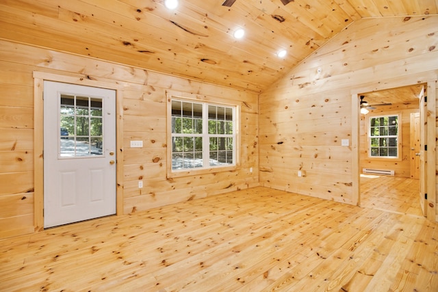 foyer entrance featuring baseboard heating, hardwood / wood-style flooring, ceiling fan, and wooden walls