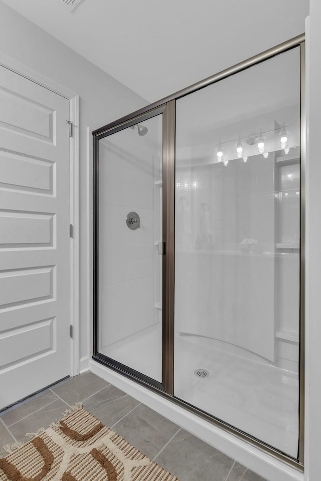 bathroom with a shower with shower door