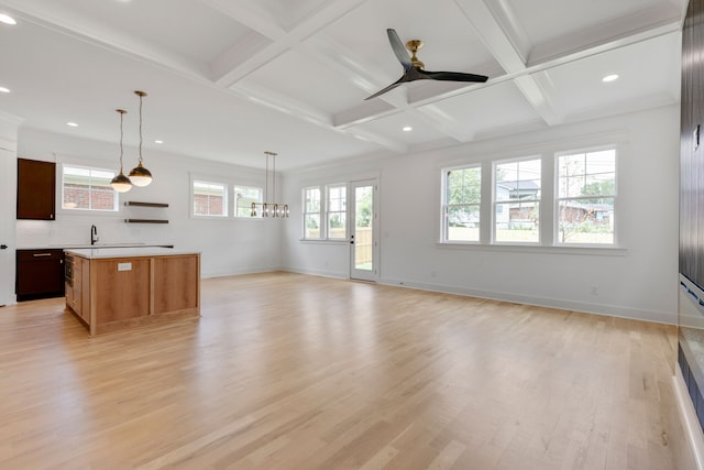 living room with light wood-type flooring, beam ceiling, and coffered ceiling