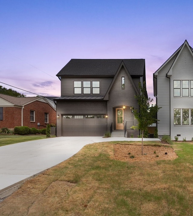 view of front facade with a garage and a yard