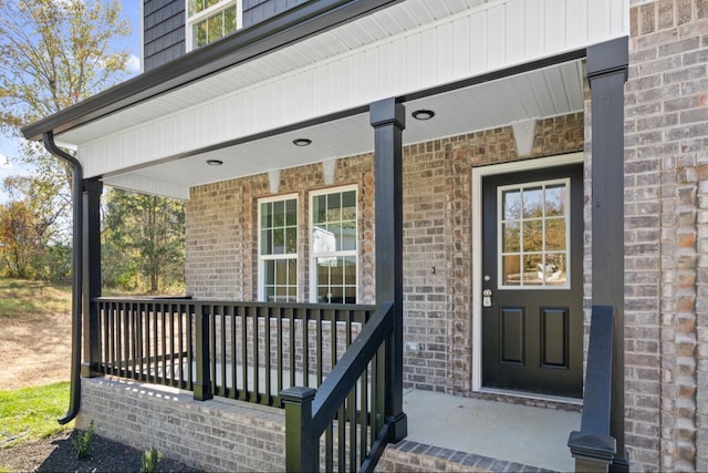 view of exterior entry with covered porch