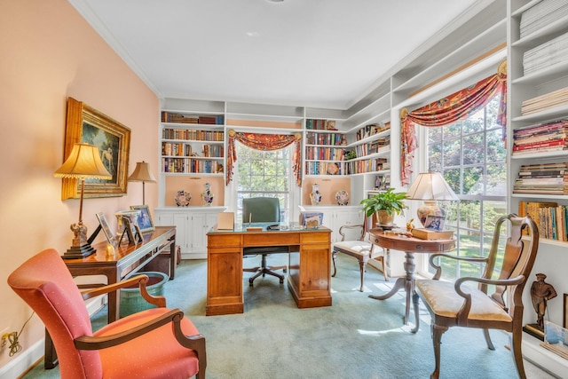 carpeted office featuring crown molding, built in shelves, and a wealth of natural light