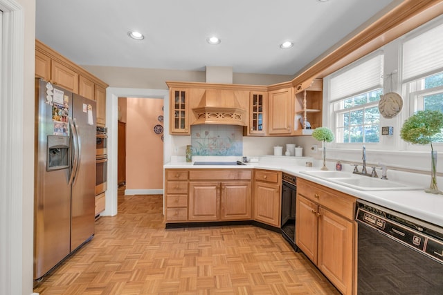 kitchen with custom range hood, light parquet floors, sink, tasteful backsplash, and black appliances