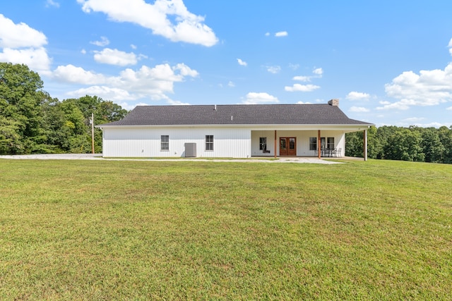 rear view of property with a lawn