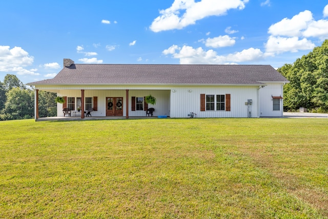 rear view of property with a lawn