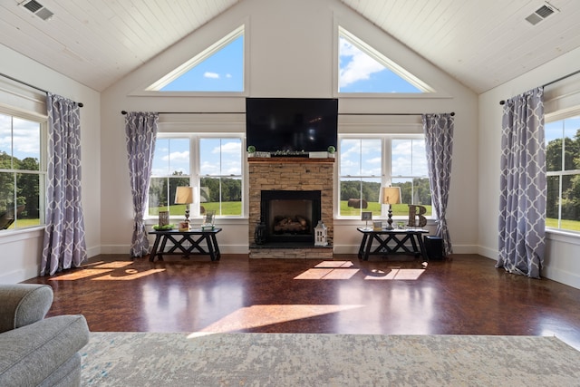 living room featuring a fireplace, plenty of natural light, and high vaulted ceiling