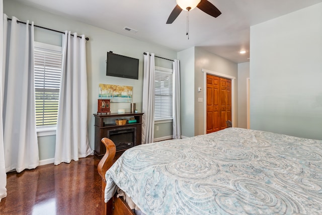 bedroom with ceiling fan, dark hardwood / wood-style floors, and a closet