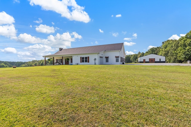 rear view of house featuring a yard