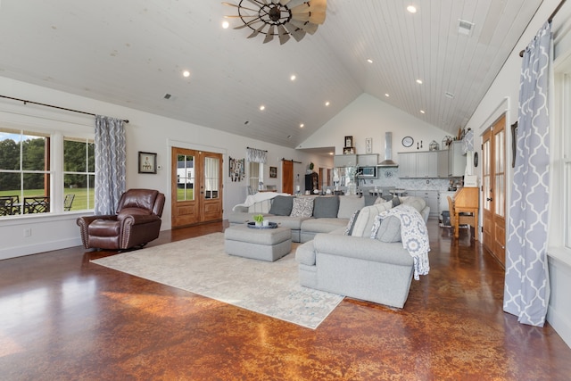 living room with high vaulted ceiling, french doors, and concrete floors