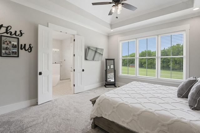 carpeted bedroom with a raised ceiling, ornamental molding, and ceiling fan