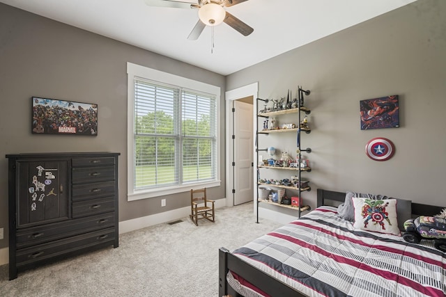 bedroom featuring light colored carpet and ceiling fan