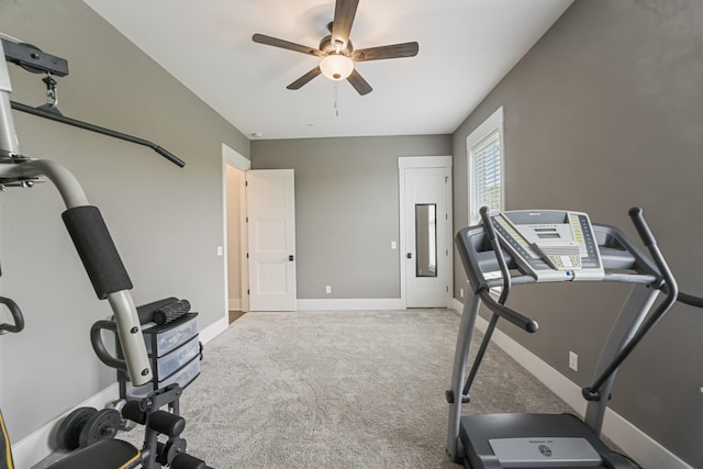 workout area with ceiling fan and light carpet