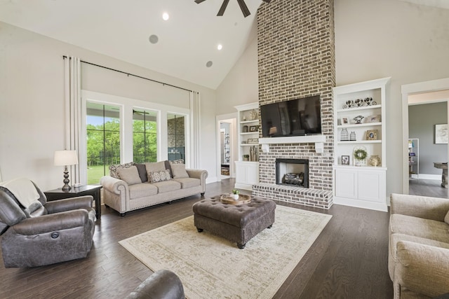 living room with dark hardwood / wood-style floors, ceiling fan, a fireplace, and high vaulted ceiling