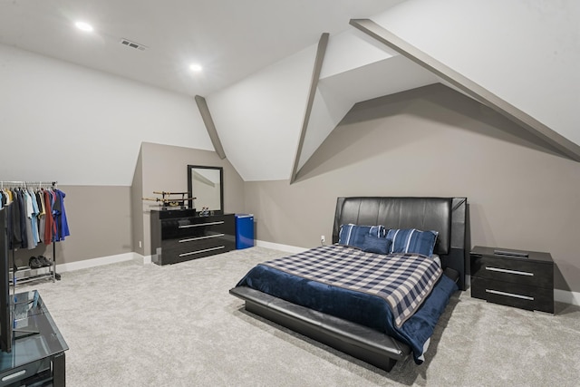 carpeted bedroom with lofted ceiling