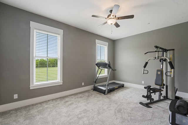 exercise room featuring light carpet and ceiling fan